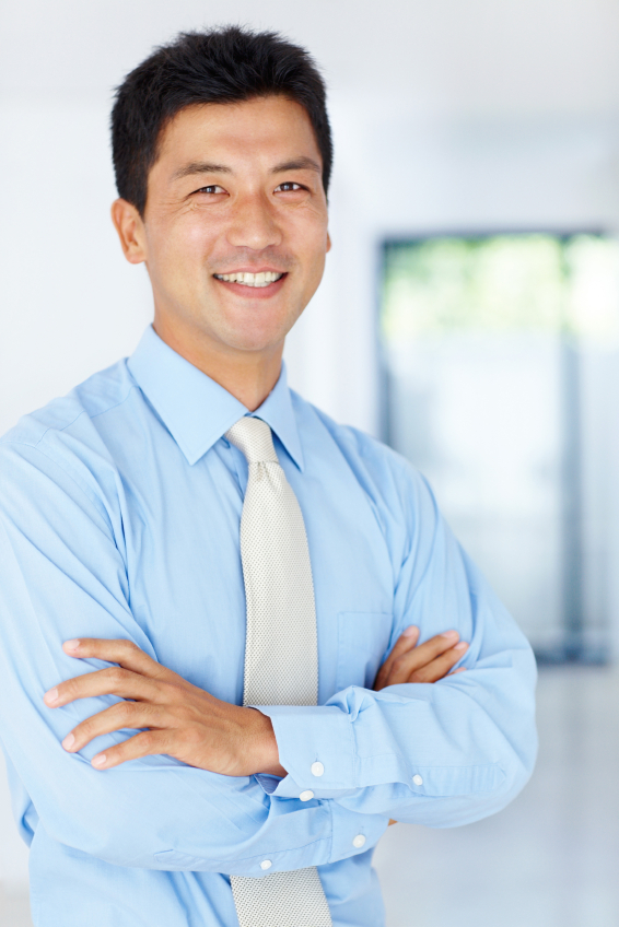 man smiling with arms crossed