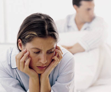 woman sitting upset on the bed