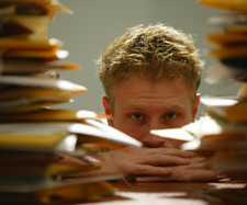 man and stack of files