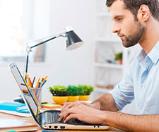 Male is working on his laptop