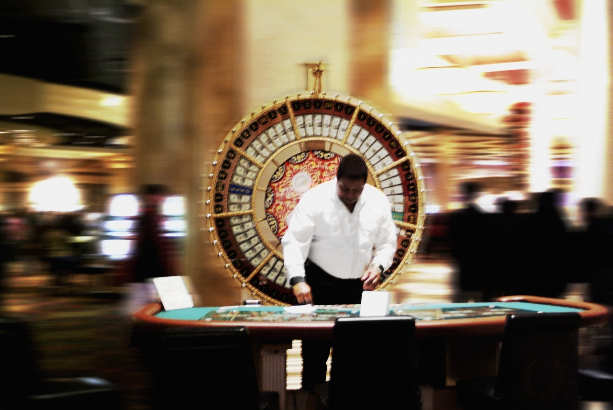 Casino worker organizing chips on the table